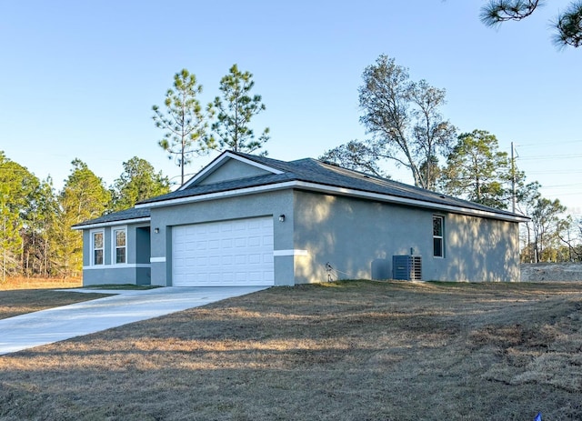 view of side of property with central AC and a garage