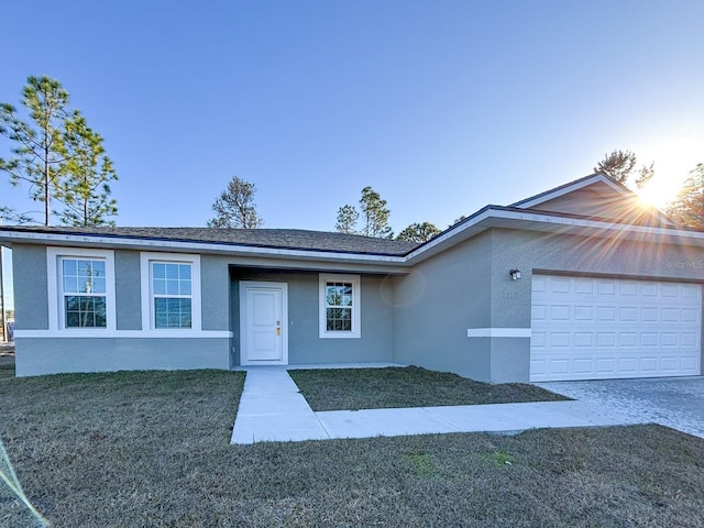 ranch-style home with a front lawn and a garage