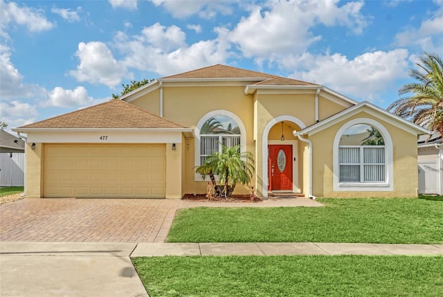 view of front facade with a garage and a front lawn