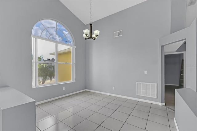 unfurnished dining area with lofted ceiling, light tile patterned floors, and an inviting chandelier