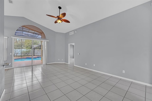 spare room featuring lofted ceiling, light tile patterned floors, and ceiling fan