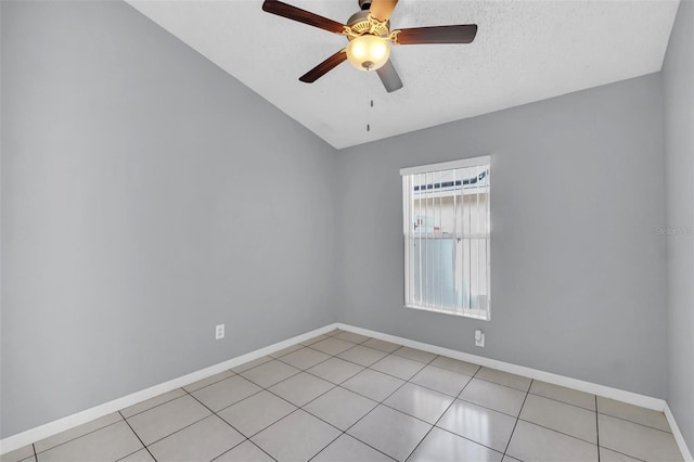 unfurnished room featuring ceiling fan, light tile patterned floors, and a textured ceiling