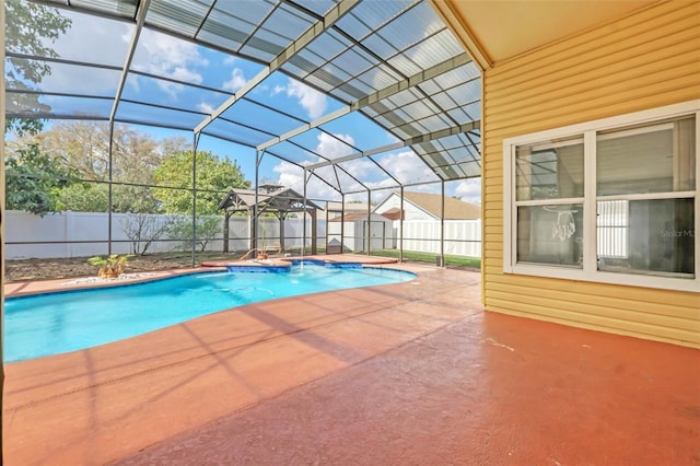 view of pool featuring a patio, glass enclosure, and a shed