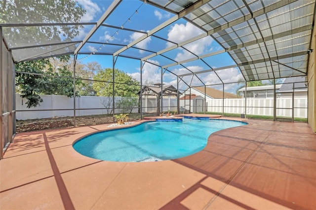 view of pool featuring a shed, a patio, and glass enclosure