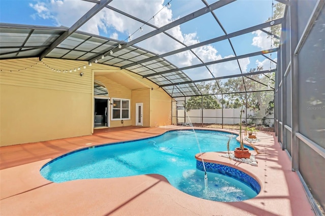 view of swimming pool featuring a patio and glass enclosure