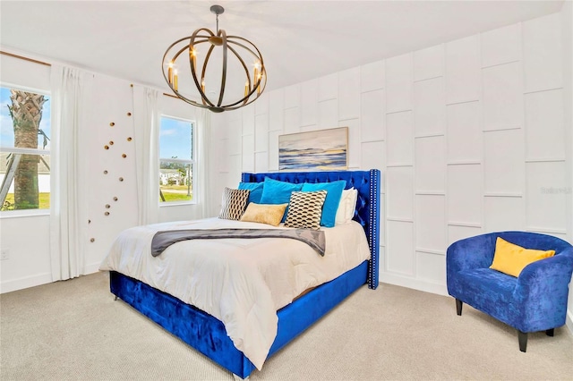 bedroom featuring light carpet, multiple windows, and an inviting chandelier