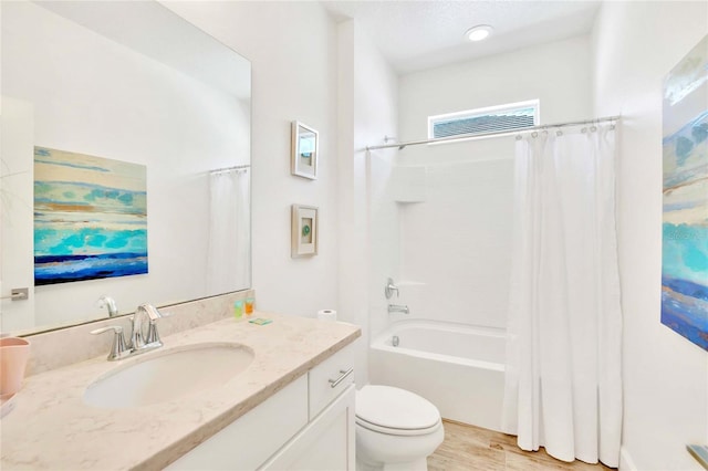 full bathroom featuring shower / bathtub combination with curtain, vanity, toilet, and hardwood / wood-style floors