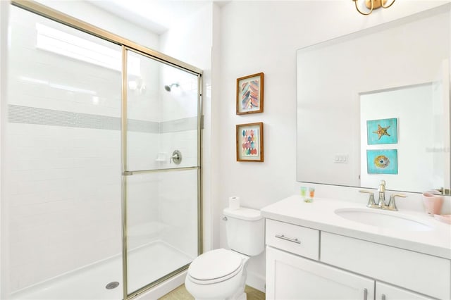 bathroom with walk in shower, vanity, and toilet