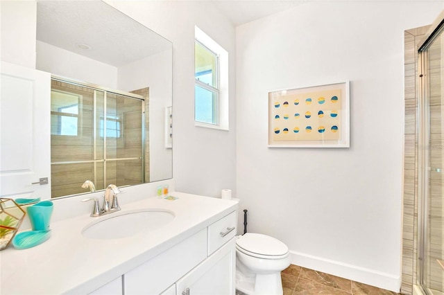 bathroom featuring vanity, a shower with shower door, tile patterned floors, and toilet