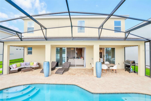 rear view of house with outdoor lounge area, a patio area, and glass enclosure