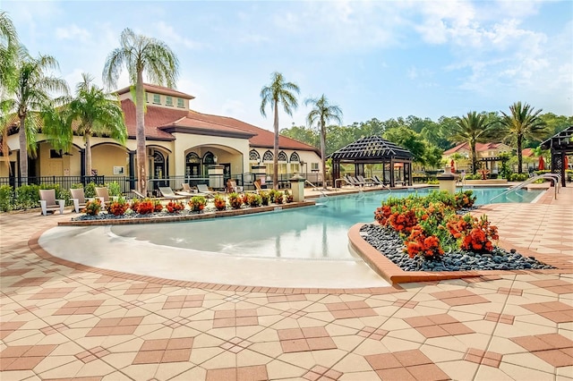 view of swimming pool with a gazebo and a patio area