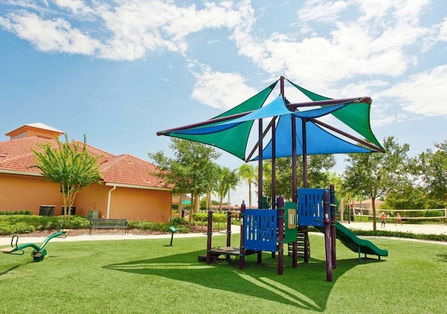 view of jungle gym featuring a yard and volleyball court