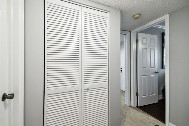 hallway with a textured ceiling