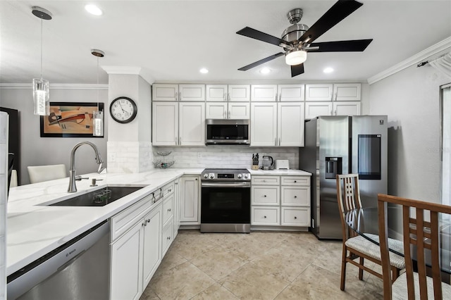 kitchen with stainless steel appliances, white cabinetry, sink, and pendant lighting