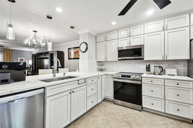 kitchen with stainless steel appliances, white cabinetry, sink, and pendant lighting