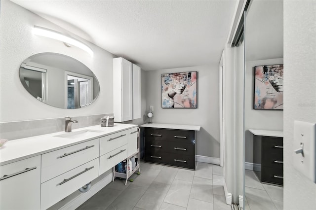 bathroom with vanity and a textured ceiling