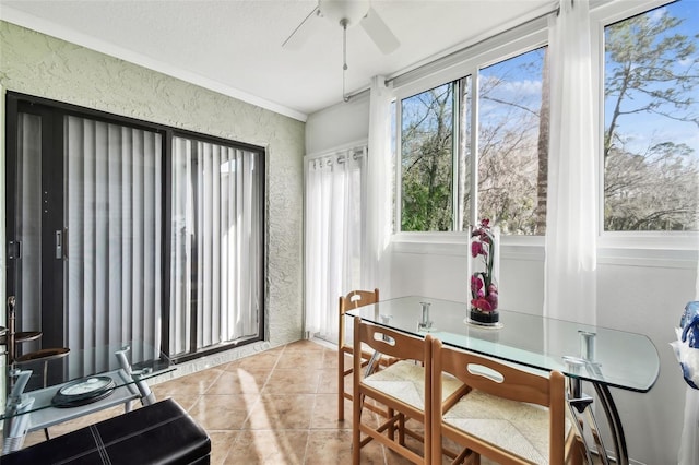 sunroom featuring ceiling fan