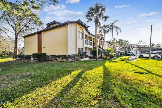 view of property exterior with a yard