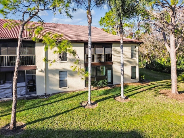 back of property featuring a lawn