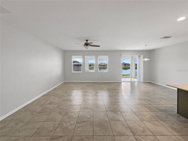 tiled empty room with ceiling fan