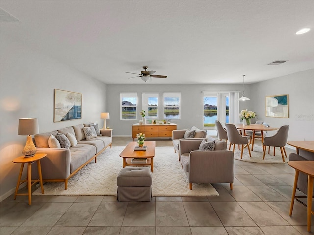 tiled living room featuring ceiling fan