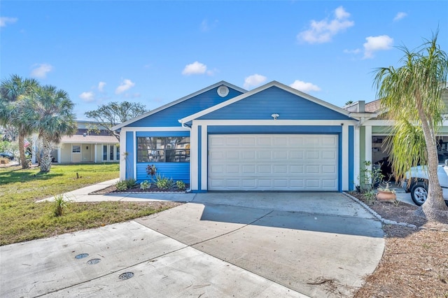 ranch-style home featuring a garage and a front lawn