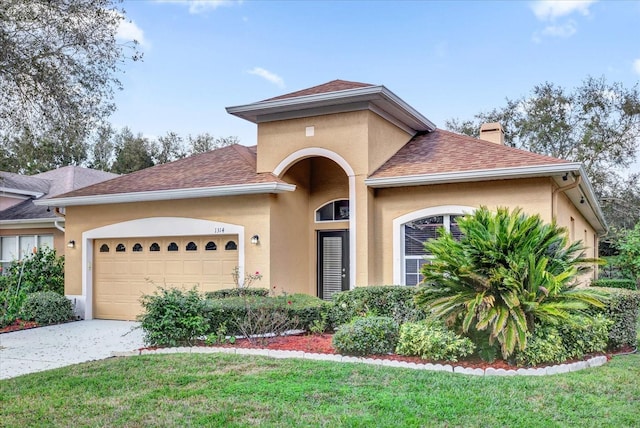 view of front of property with a garage and a front yard