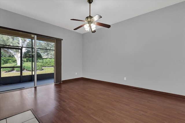 spare room featuring dark hardwood / wood-style flooring and ceiling fan