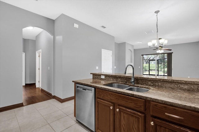 kitchen featuring sink, light tile patterned floors, dishwasher, hanging light fixtures, and a notable chandelier