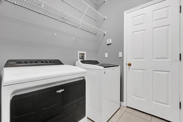 washroom featuring light tile patterned flooring and separate washer and dryer