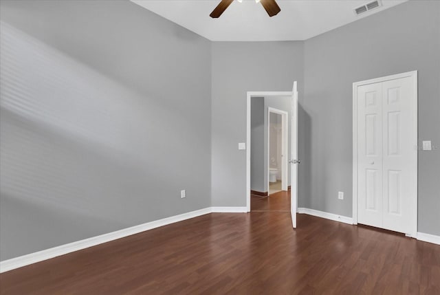 spare room featuring ceiling fan and dark hardwood / wood-style flooring