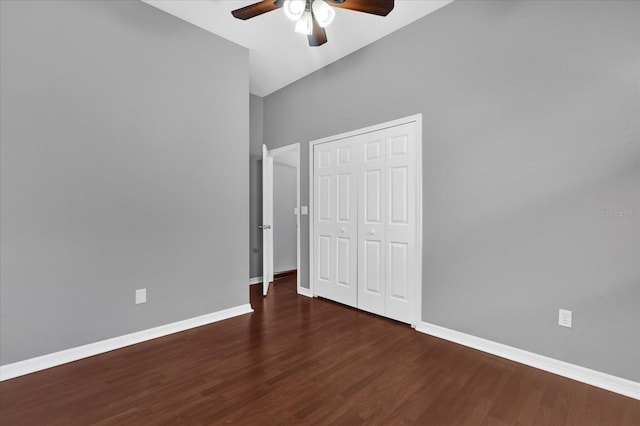 unfurnished bedroom with ceiling fan, dark hardwood / wood-style flooring, and a closet