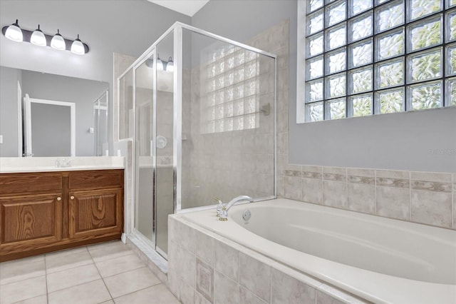 bathroom with tile patterned flooring, vanity, and shower with separate bathtub