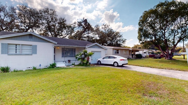 single story home featuring a porch, a garage, and a front yard