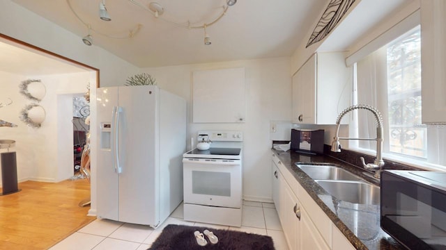 kitchen with white cabinetry, sink, white appliances, and a healthy amount of sunlight