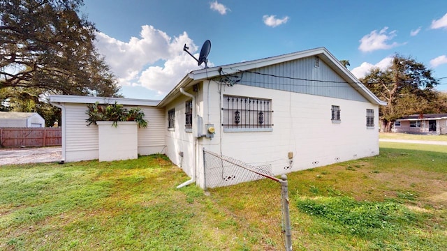 rear view of property featuring a lawn