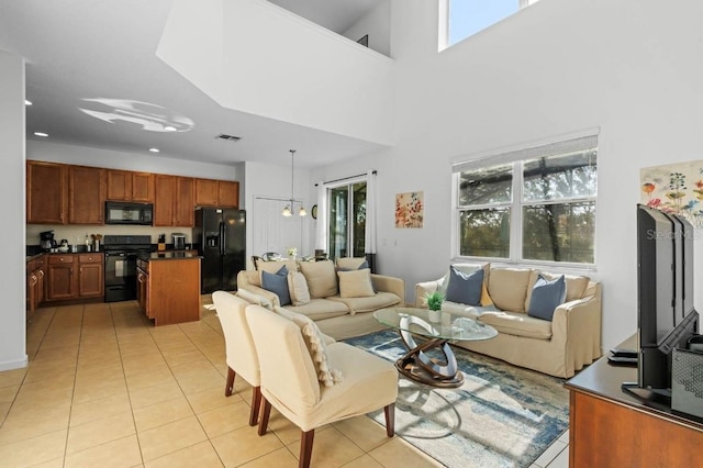 tiled living room featuring a chandelier