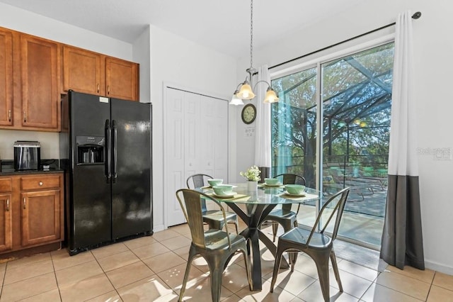 dining area featuring light tile patterned flooring and an inviting chandelier