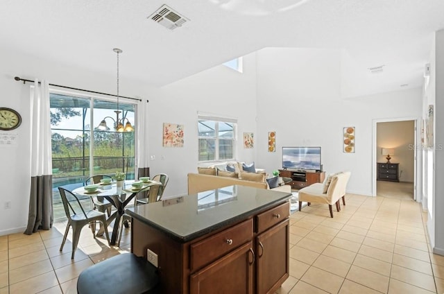 kitchen featuring a kitchen island, hanging light fixtures, an inviting chandelier, and light tile patterned floors