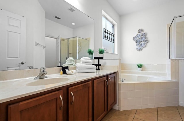 bathroom featuring tile patterned floors, vanity, and plus walk in shower