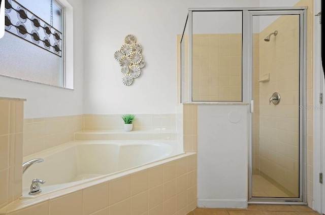 bathroom with separate shower and tub and tile patterned flooring