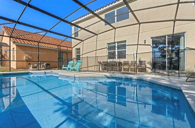 view of swimming pool featuring a patio and a lanai