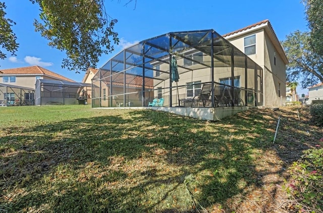 back of property featuring a yard and a lanai