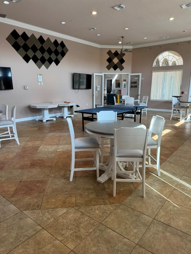 dining room featuring a textured ceiling, crown molding, and tile patterned floors