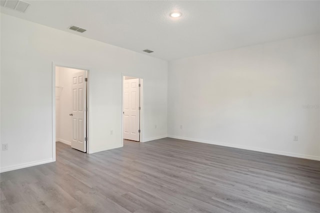 spare room with wood-type flooring