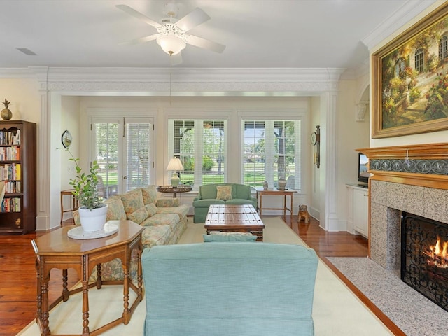 sunroom / solarium with a ceiling fan, a healthy amount of sunlight, and a premium fireplace