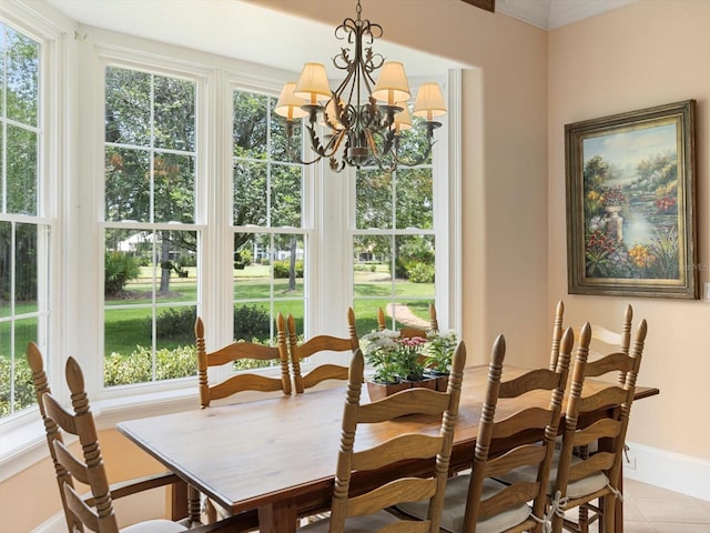 dining area with a chandelier, light tile patterned flooring, and baseboards