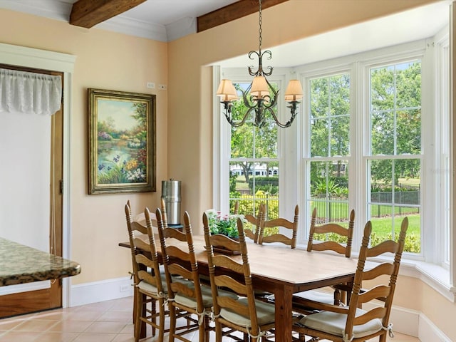 dining space featuring a chandelier, a wealth of natural light, light tile patterned flooring, and baseboards