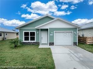 view of front of property featuring a garage and a front yard