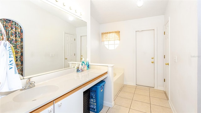 bathroom featuring tile patterned flooring, vanity, and a bath